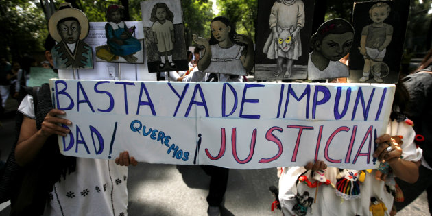 Relatives of victims of the June 5 fire at a daycare centre in the Mexican state of Sonora march to protest against federal and local authorities in Mexico City, July 4, 2009. Hundreds of residents marched on Saturday to demand justice for the victims of the fire that have killed 48 children, according to local media. The banner in Spanish reads: "Enough of impunity, we want justice". REUTERS/Eliana Aponte (MEXICO POLITICS CONFLICT)